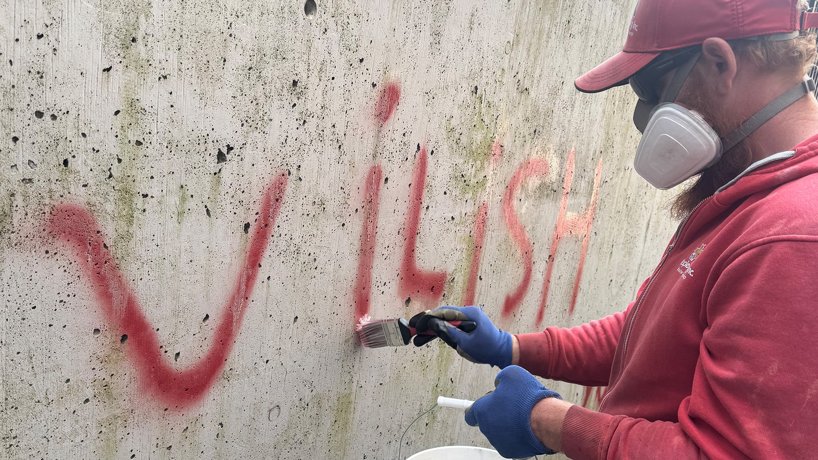 Professional-Graffiti-Removal-for-Homes-&-Businesses-min Professional graffiti removal services restoring a brick wall to its original clean surface.
