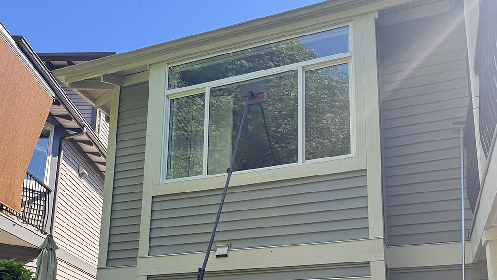 A-Tailored-Cleaning-Plan-for-Your-Home Professional pressure washing and power washing cleaning a concrete driveway to remove grime and oil stains for a spotless finish.