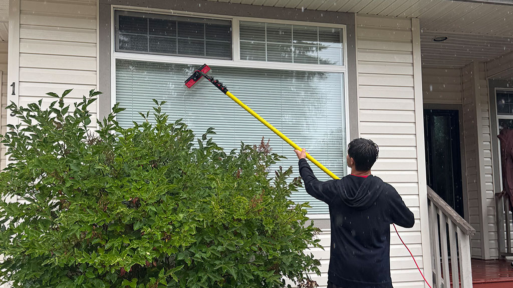 Give-Your-Home-the-Fresh-Start-It-Deserves Professional exterior cleaning service restoring a home’s siding and driveway in Metro Vancouver using eco-friendly methods.
