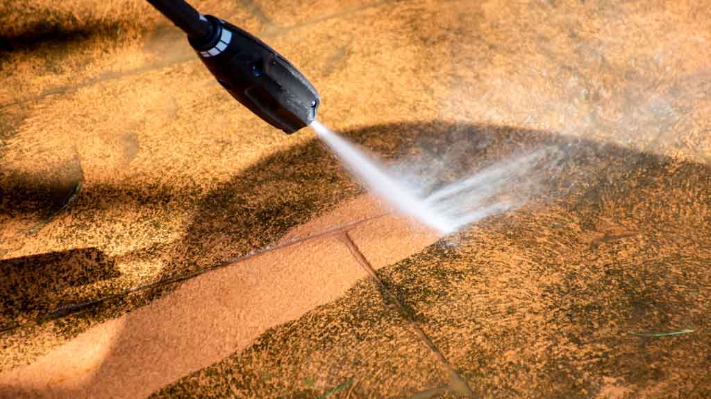 Business Pressure washing Cleaning paving tiles pathway with high pressure washer.